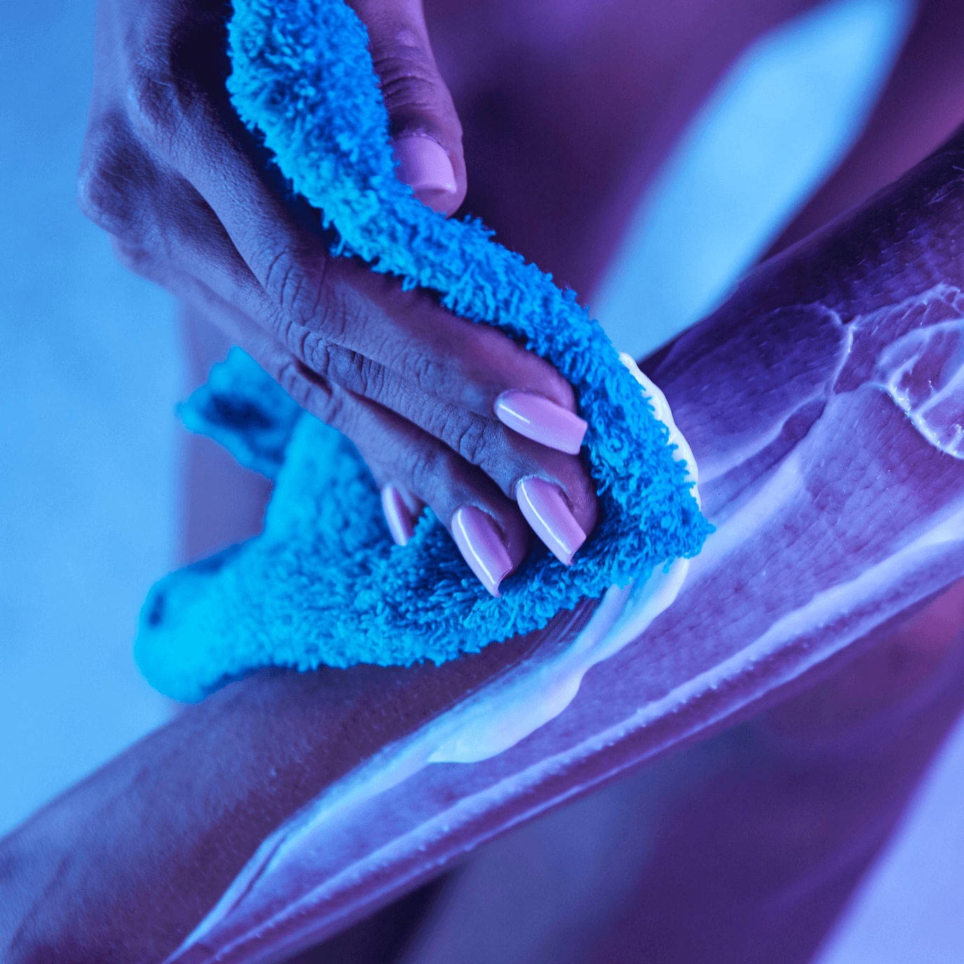 Person using wash cloth to remove Nair hair removal cream.